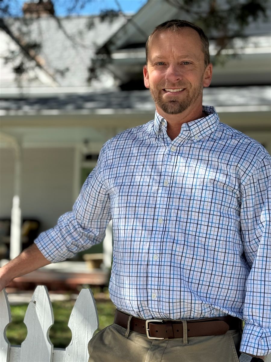 Mike Chappell, owner-operator of Peak City Home Inspections, at a picket fence in downtown Apex, NC